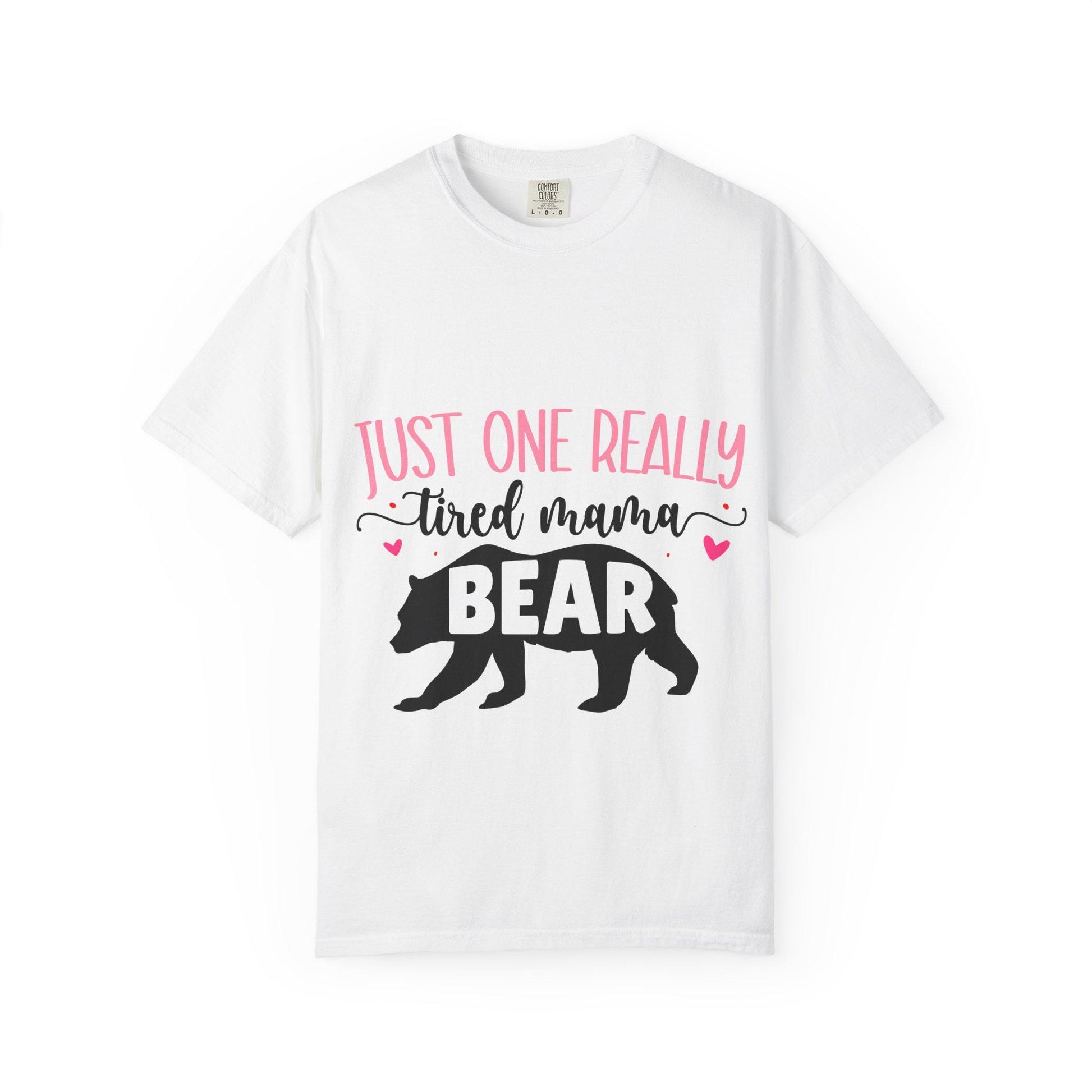 White Comfort Colors short sleeve t-shirt featuring the phrase “Just One Really Tired Mama Bear” in playful pink and black fonts. The design includes a bold black silhouette of a walking bear with the word “BEAR” in pink block letters inside the bear, and small pink hearts for added charm. A cozy, fun, and relatable shirt for moms, perfect for Mother’s Day, new moms, or as a comfy everyday mom life tee.
