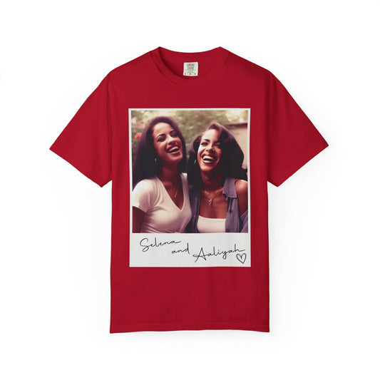 May include: Red t-shirt with a white photo of two women smiling. The photo is in a white frame with the text 'Selena and Aaliyah' and a heart.