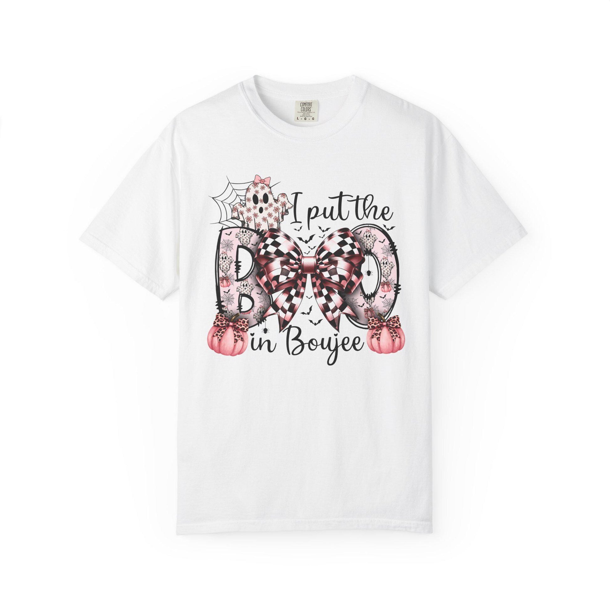 White short-sleeve t-shirt with a playful Halloween-themed design that reads “I put the BOO in Boujee.” The word “BOO” is decorated with black and pink patterns, including leopard print and buffalo plaid, accented by a large checkered bow. Surrounding the text are cute seasonal details such as pink pumpkins, a ghost, bats, and a spider web, giving the shirt a stylish and boujee spooky vibe.